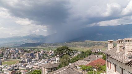 Obraz premium Panorama showing Gjirokastra city from the viewpoint with many typical historic houses of Gjirokaster timelapse.
