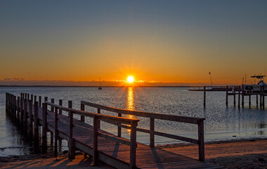 Fototapeta na wymiar A Public Dock At Sunrise Time On Barnegat Bay In NJ