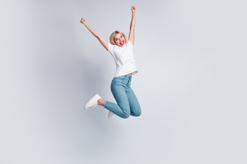 Full size photo of overjoyed woman dressed white t-shirt denim pants flying win lottery raisng...