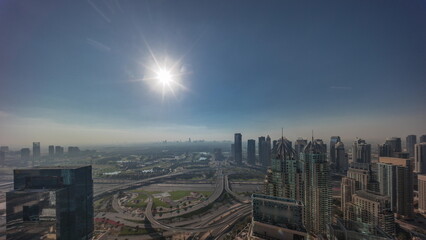 Naklejka na ściany i meble Sunrise over Dubai marina and JLT skyscrapers along Sheikh Zayed Road aerial timelapse.