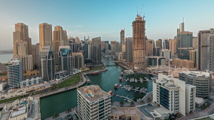 Panorama showing Dubai Marina skyscrapers and JBR district with luxury buildings and resorts aerial timelapse