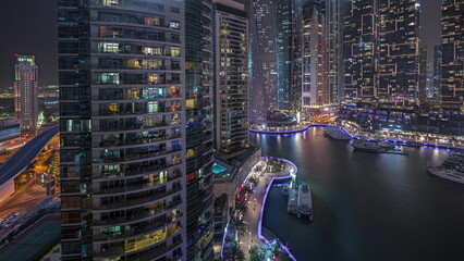 Fototapeta na wymiar Panorama showing luxury yacht bay in the city aerial night timelapse in Dubai marina