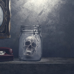 Creepy decoration in a dark home: human skull in a jar