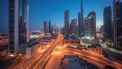 Aerial view of Dubai Downtown skyline with many towers night to day timelapse.