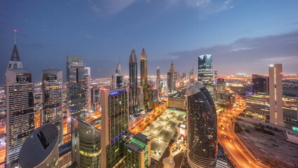 Skyline view of the high-rise buildings on Sheikh Zayed Road in Dubai aerial night to day...