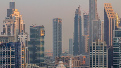 Cityscape with skyscrapers of Dubai Business Bay and water canal aerial morning timelapse.