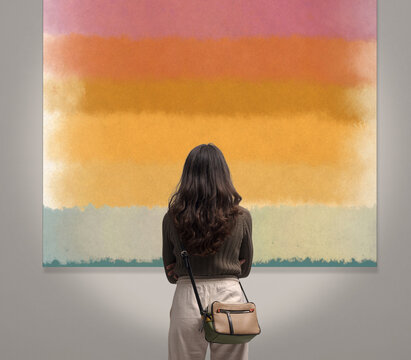 Woman looking at paintings at the art exhibition