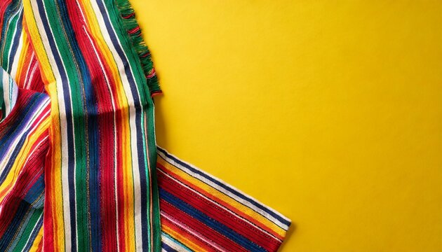 mexican national holiday concept top view photo of colorful striped serape on bright yellow background with empty space