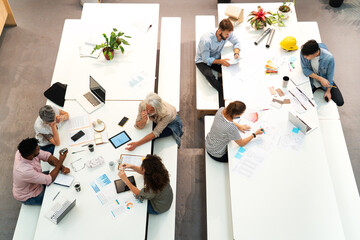 Wide view of place of work full of people having casual meetings