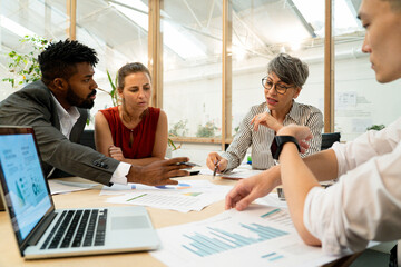 Businesswoman discussing with colleagues during meeting