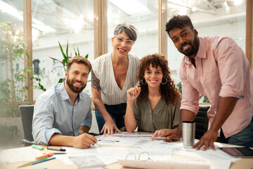 Group of engineers and architects looking at the camera during meeting