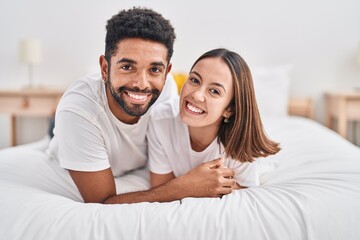 Man and woman couple smiling confident lying on bed at bedroom