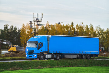 Front view of the European truck vehicle on a motorway with dramatic sunset light. Concept of cargo...