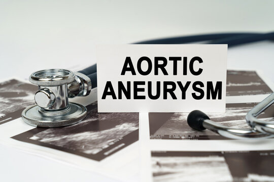 On the ultrasound pictures there is a stethoscope and a business card with the inscription - Aortic aneurysm