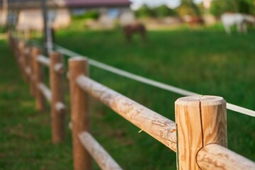 Wooden fence barrier at farm grounds for cattle and territory protection