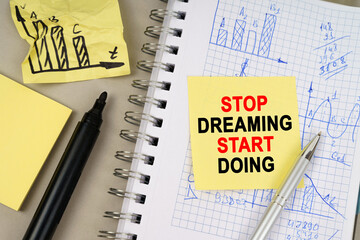 On the table there is a notepad with notes and sticky notes with the inscription - Stop Dreaming...
