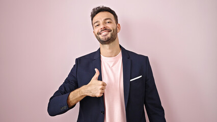 Young hispanic man business woman doing ok sign with thumb up over isolated pink background