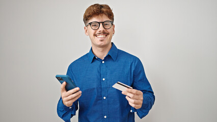 Young hispanic man using smartphone and credit card over isolated white background