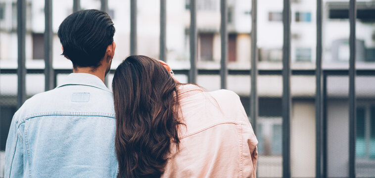 Back View Of Asian Couple Dating Outdoor. Woman Put Head On Boyfriend's Shoulder And Talking Together. Love And Relationship Concept. Copy Space