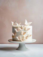Large white cream cake on a stand, decorated with sugar butterflies