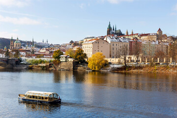 Obraz premium Snowy Prague Lesser Town with Prague Castle above River Vltava in the sunny Day , Czech republic