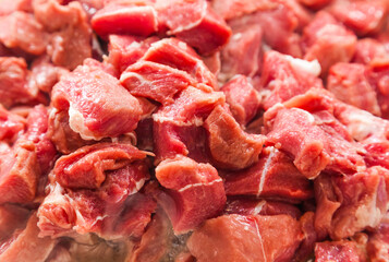 Diced pieces of raw beef roast, close-up.