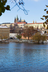 Obraz premium Snowy Prague Lesser Town with Prague Castle above River Vltava in the sunny Day , Czech republic