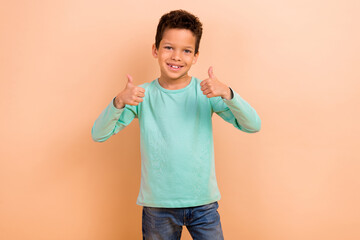 Photo of satisfied nice boy wear stylish turquoise clothes recommend boutique two thumbs up...