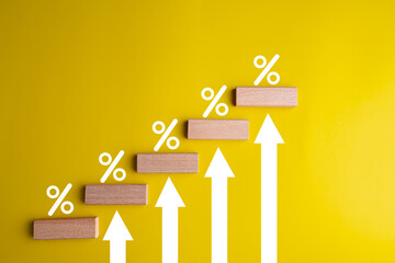 block wooden percentage sign and step up, financial growth, interest rate increase, inflation, high price and tax rise concept.