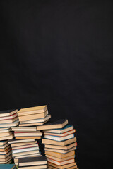 Many stacks of educational books to study in the university library on a background