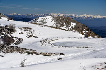 Fototapeta na wymiar Winter landscape with frozen lake at Mount Avgerinos in Epirus, Greece