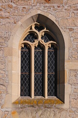 Pointed gothic window arch with mouchette tracery at the village church of Abtweiler, Pfalz region...