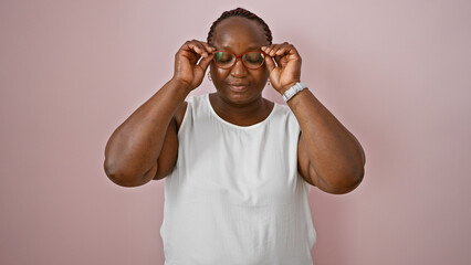 Cool and relaxed, an overweight african american adult woman stands poised, her serious expression...