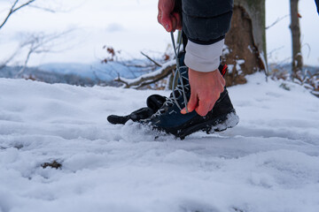 Close-up of tying a mountain boot in winter