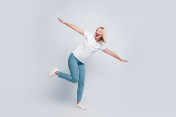 Full length photo of overjoyed girl with bob hair dressed white t-shirt flying look at sale empty...