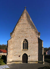 Fototapeta premium Medieval church with symmetrical gothic sandstone facade in the village of Abtweiler, Pfalz region in Germany