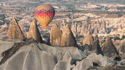 colorful hot air balloon flying close to the fairy chimneys, Cappadocia, Turkey