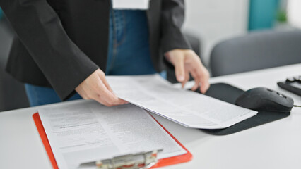 Young blonde woman business worker holding document at the office
