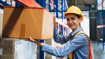 Warehouse worker working and checking the stock in the warehouse. .Factory manager using digital tablet check barcode in industry factory logistic.