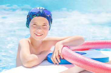 Healthy lifestyle. Active child (boy) in cap, sport goggles ready to learns professional swimming...