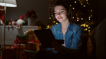 Young caucasian woman doing christmas online shopping with tablet at home
