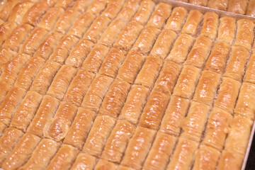 Golden pastries glisten in neat rows, a testament to baking mastery. Amid health trends, their sugar glaze raises nutritional concerns.