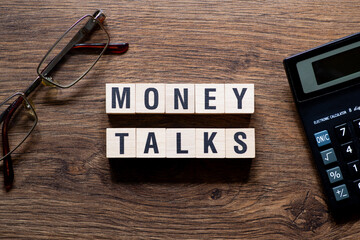 Money talks - word concept on building blocks, text