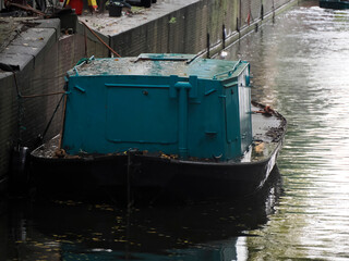 Fototapeta na wymiar Boat on canals of Amsterdam view on rainy day
