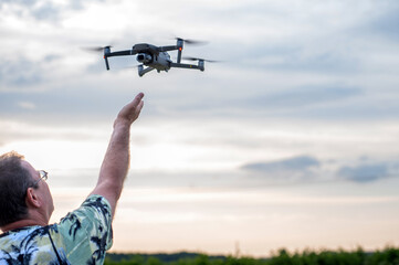 A drone lands on the hand of a man after a successful flight.