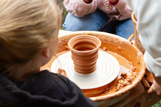 Pottery training. Rotating a clay pot on a machine. Hands knead clay. Making a clay pot.