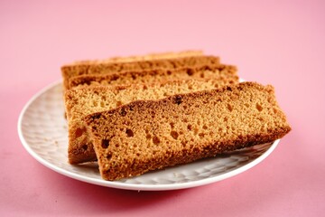 Homemade Indian cake rusk | Dry biscuits isolated on pink background, selective focus