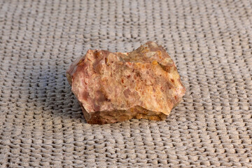 Pelitic Schist Rock on beige knitted fabric Background