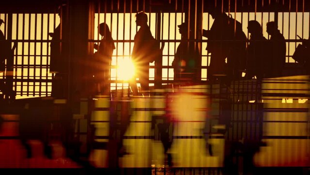 A lot of people walking on vapor or airport in front of sunset