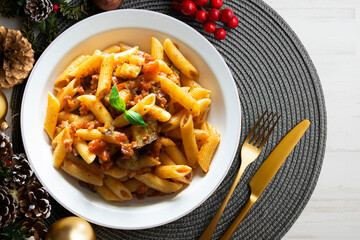 Pasta alla norma traditional italian recipe. Dish served on a table with christmas decoration. - obrazy, fototapety, plakaty